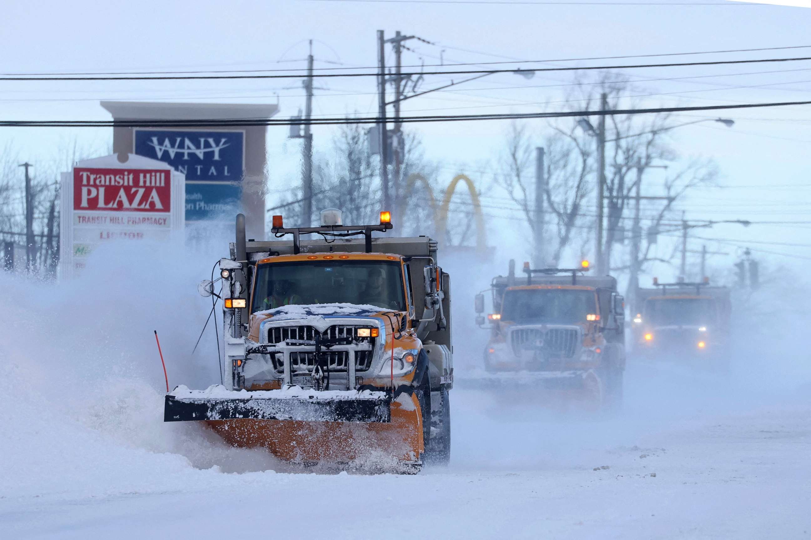 PHOTO: Snow plows clear the roads following a winter storm that hit the Buffalo region in Lancaster, New York, December 25, 2022.