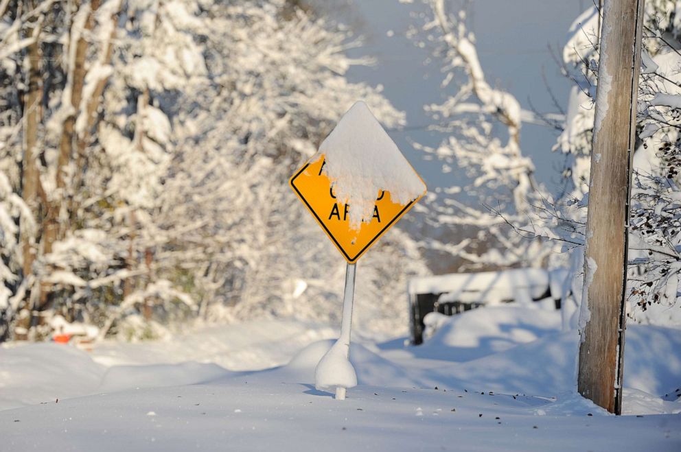 PHOTO: A snow covered sign protrudes from the snow after an intense lake-effect snowstorm impacted the area on Nov. 19, 2022, in Hamburg, N.Y.