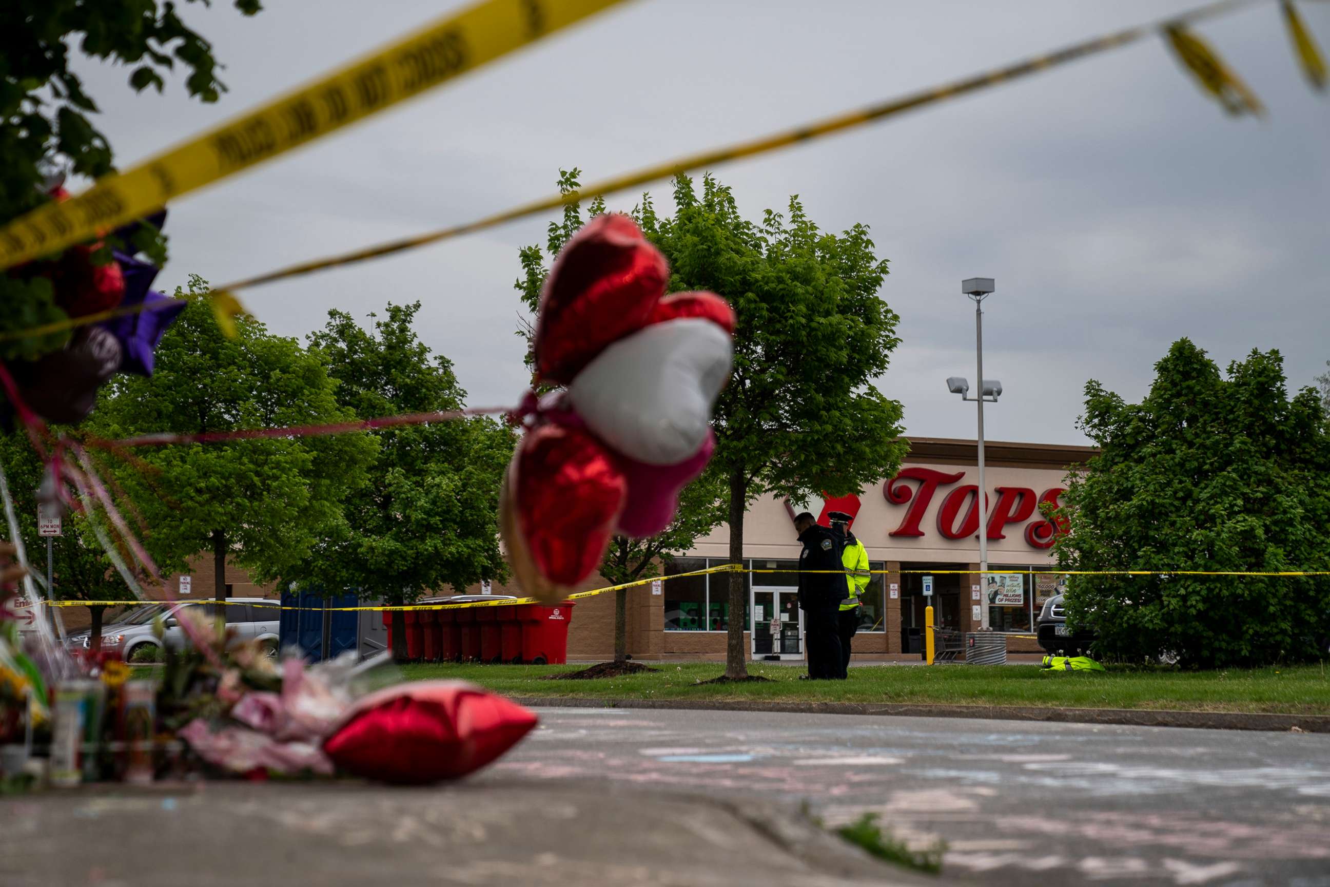 PHOTO: People gather at the scene of a mass shooting at Tops Friendly Market at Jefferson Avenue and Riley Street in BUffalo, New York, May 16, 2022.