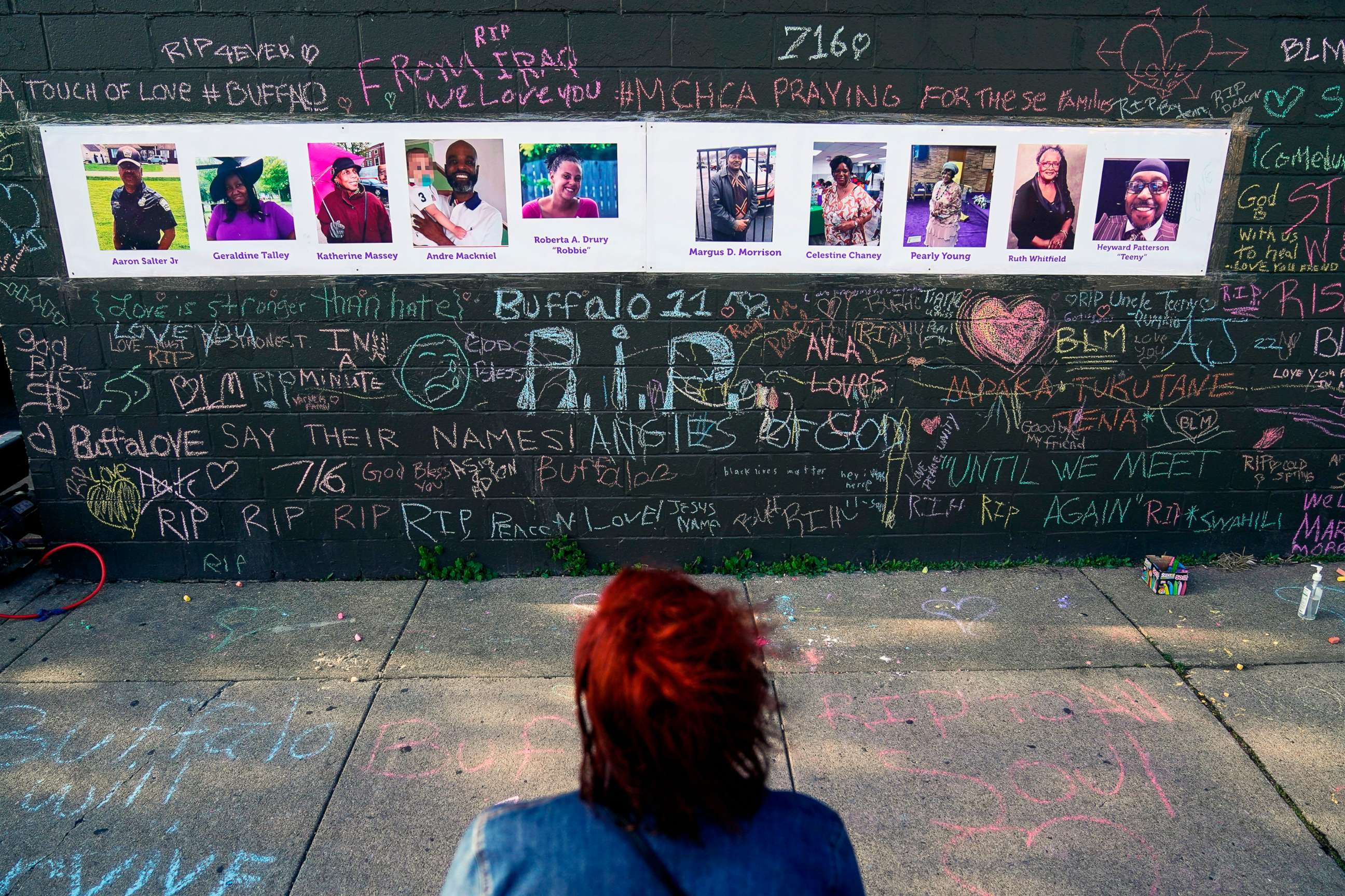 PHOTO: A person visits a makeshift memorial near the scene of the shooting at a supermarket, in Buffalo, N.Y., May 19, 2022.