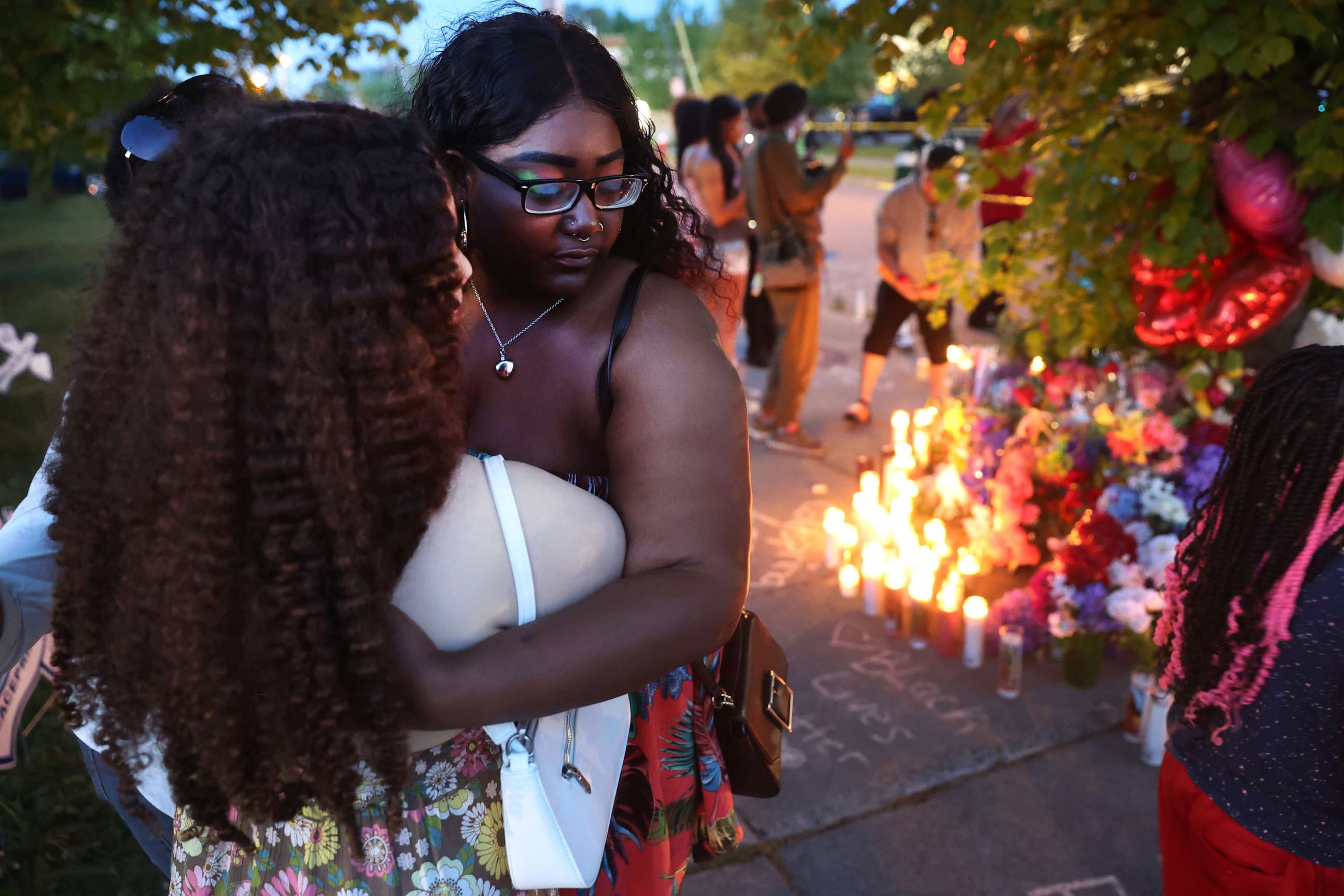 PHOTO: Mourners support each other while visiting a makeshift memorial outside of Tops market, May 15, 2022 in Buffalo, New York.