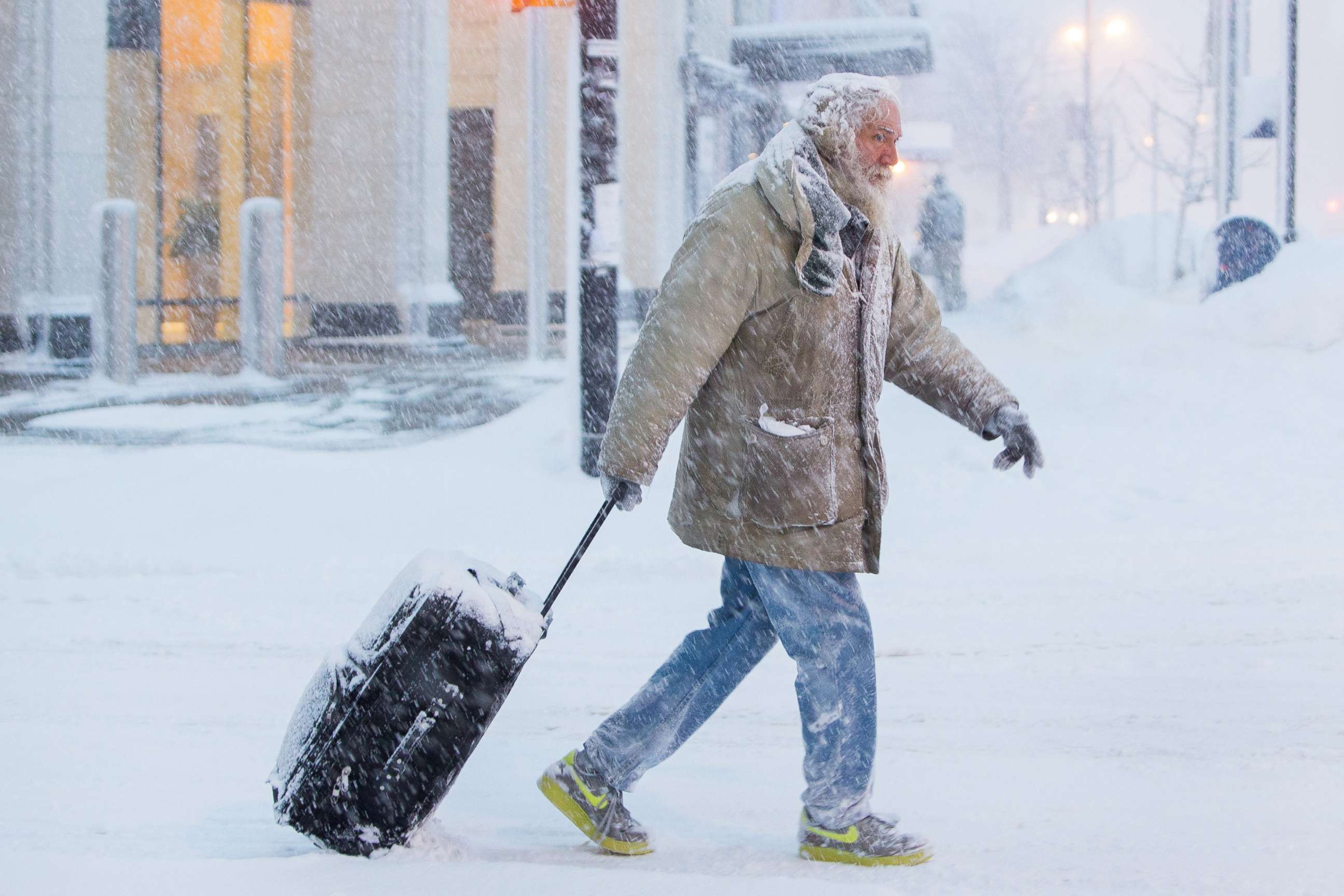 PHOTO: Man moves luggage in snow during a winter storm in Buffalo, N.Y., Jan. 30, 2019. 