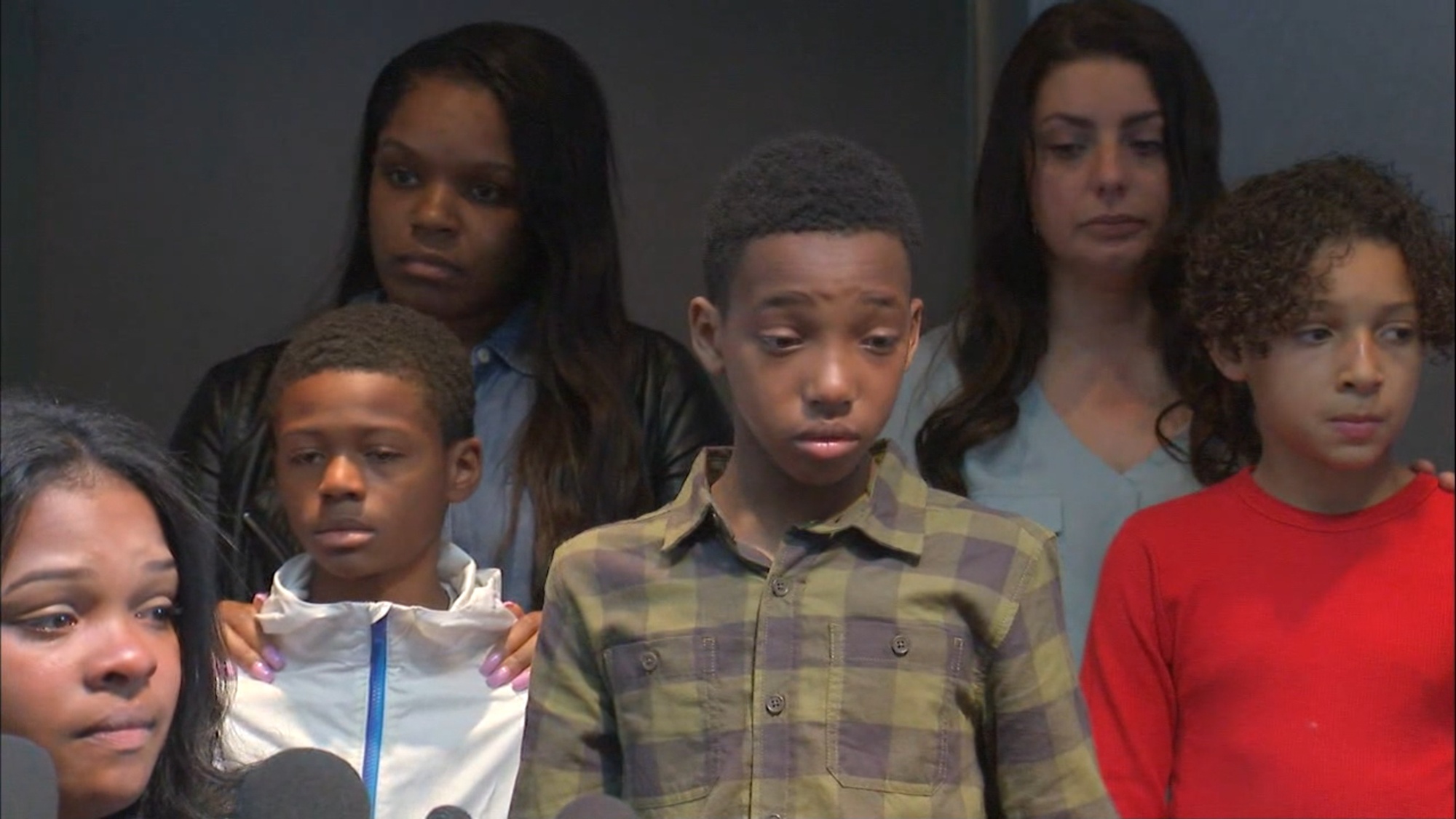 PHOTO: Friends and family members listen as Ashley Smith, lower left, talks about an allegedly racist incident at a Buffalo Wild Wings in Naperville, Ill., during a press conference on Nov. 5, 2019.