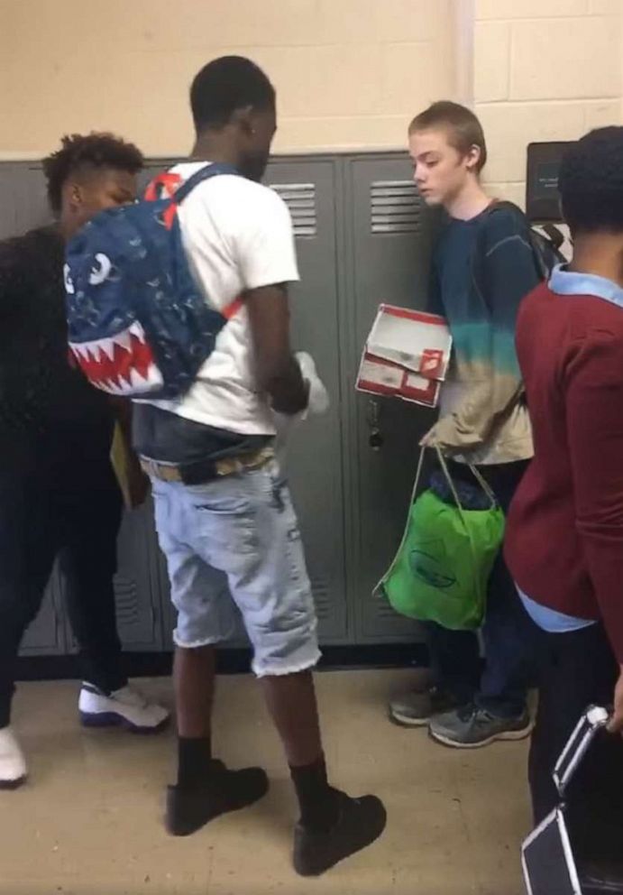 PHOTO: A student who was bullied for often wearing the same clothes to school is gifted new clothes and new shoes from his classmates.