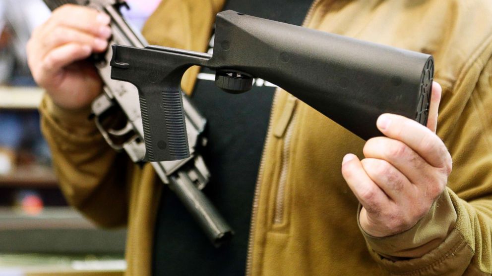 A bump stock device (right), that fits on a semi-automatic rifle to increase the firing speed, making it similar to a fully automatic rifle, is shown next to a AK-47 semi-automatic rifle at a gun store on Oct. 5, 2017, in Salt Lake City, Utah.   