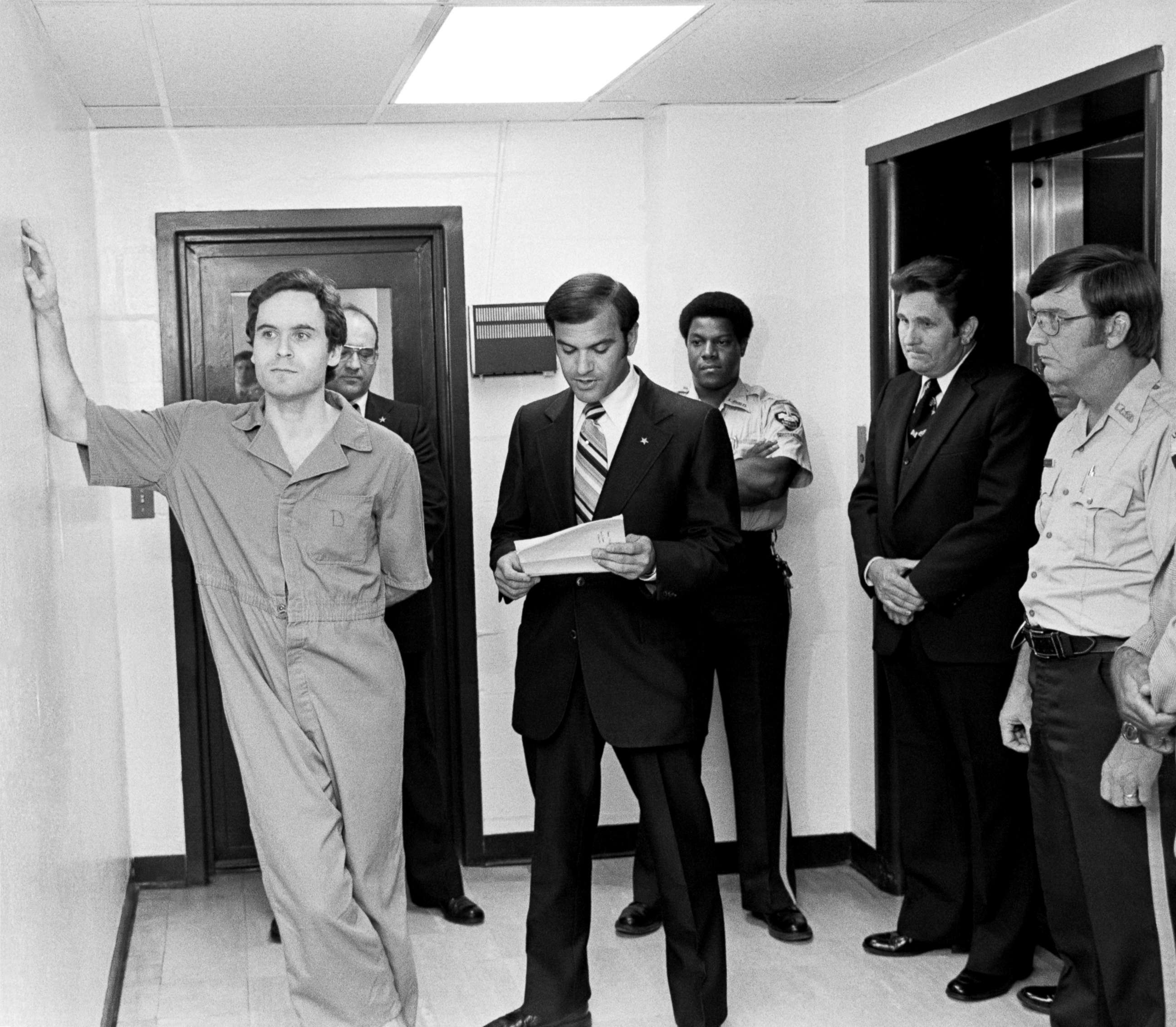 PHOTO: Suspected murderer Ted Bundy leans on the Leon County jail wall as an indictment charging him with the murders of two FSU coeds at the Chi Omega house is read by Leon County Sherriff Ken Katarsis in Tallahassee, Fla., July 27, 1978.