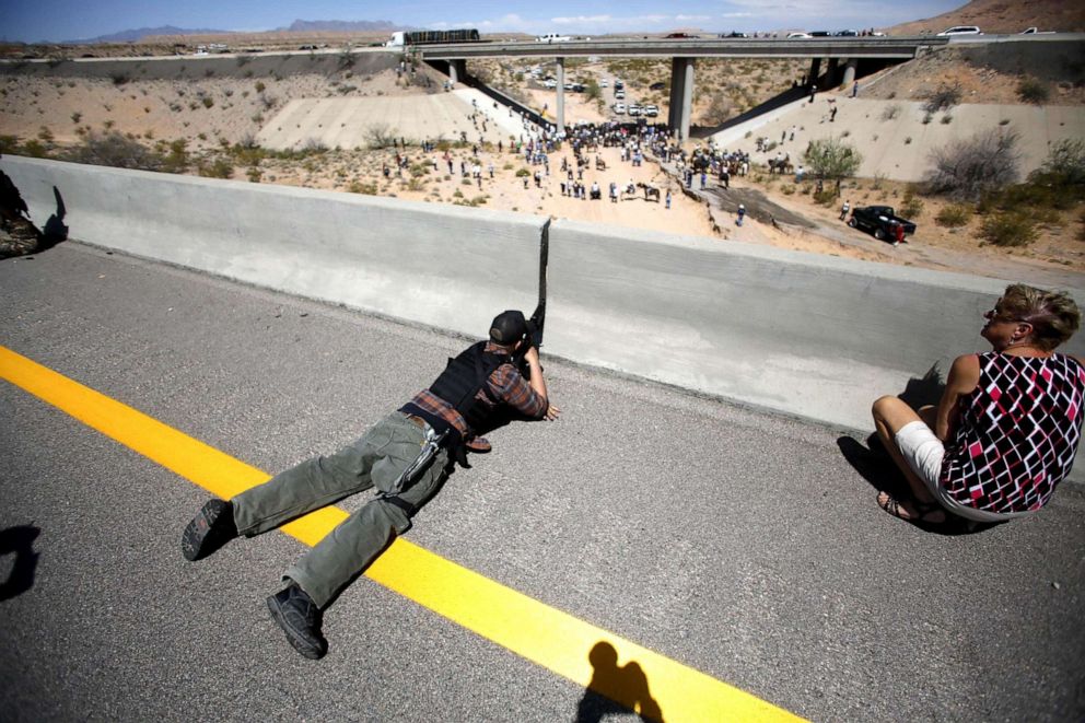 PHOTO: In this April 12, 2014, file photo, Eric Parker aims his weapon from a bridge as protesters gather by the Bureau of Land Management's base camp, where cattle that were seized from rancher Cliven Bundy are being held, near Bunkerville, Nev.