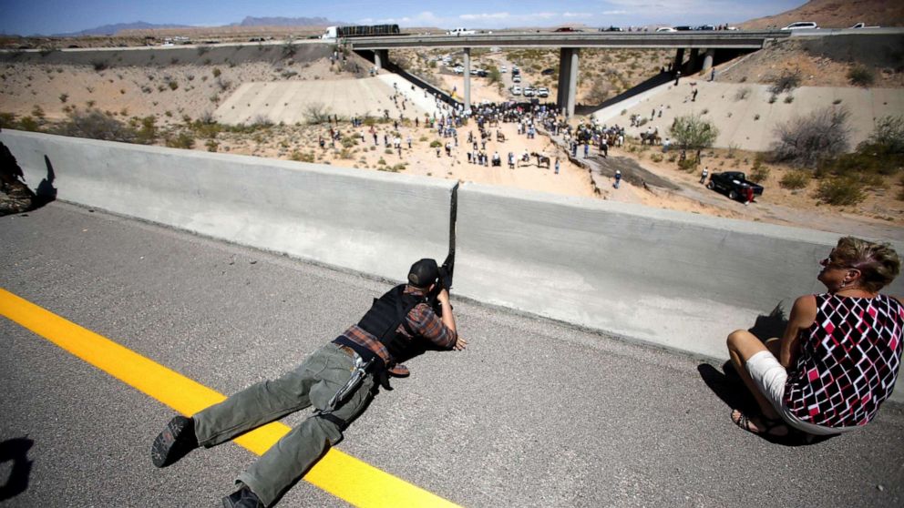 PHOTO: In this April 12, 2014, file photo, Eric Parker aims his weapon from a bridge as protesters gather by the Bureau of Land Management's base camp, where cattle that were seized from rancher Cliven Bundy are being held, near Bunkerville, Nev.