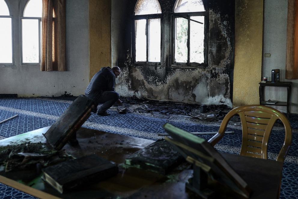 PHOTO: A Palestinian man looks at the damage in the Hajja Hamida Mosque after it was reportedly set on fire and vandalized by Israeli settlers in the Palestinian village of Deir Istiya, near Salfit in the Israeli-occupied West Bank, on November 13, 2025.