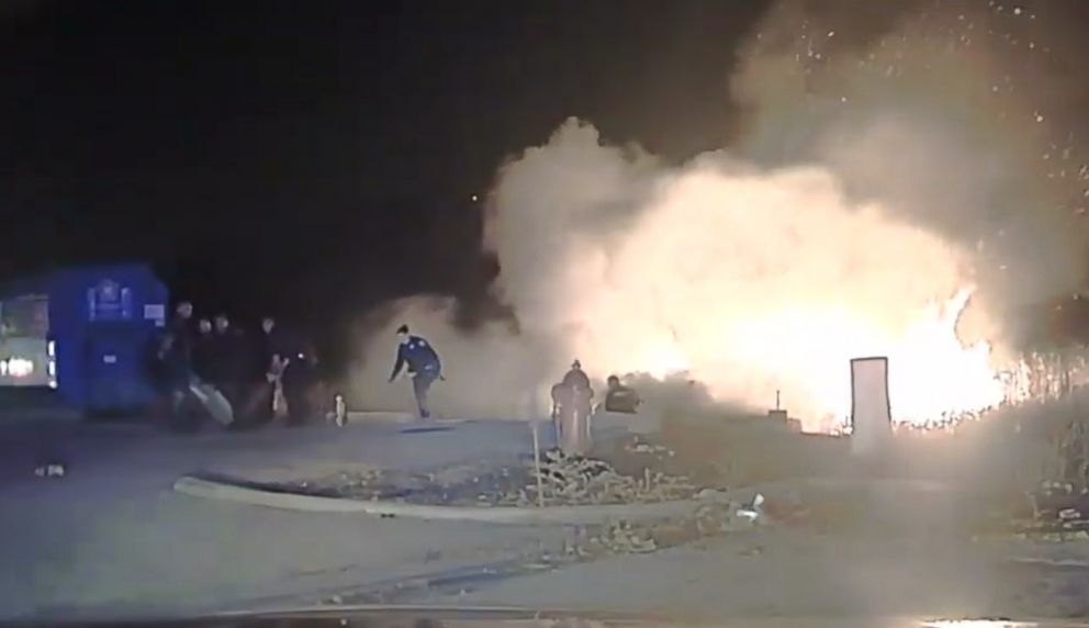 PHOTO: An image made from video shows police officers from Oswego, Ill., dragging a man from a burning vehicle on Nov. 28, 2017.