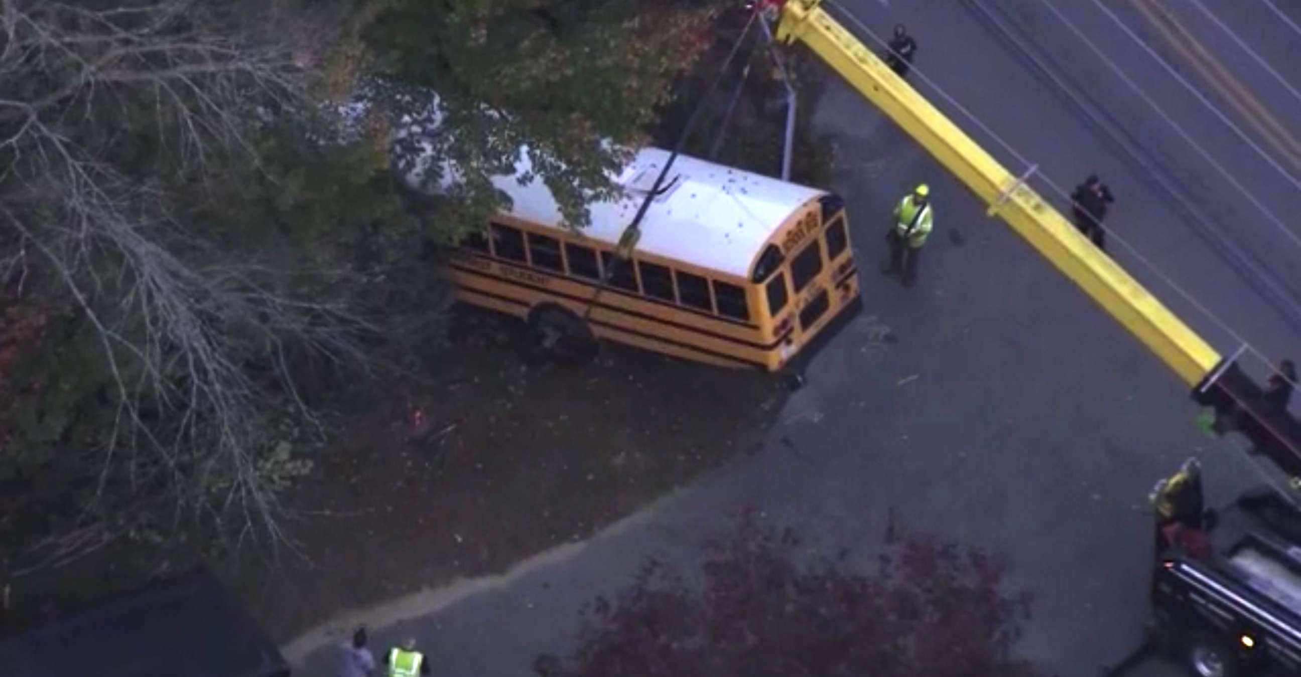 PHOTO: Two moms rescue children after their school bus crashed into the woods in Plaistow, N.H., Oct. 12, 2021.
