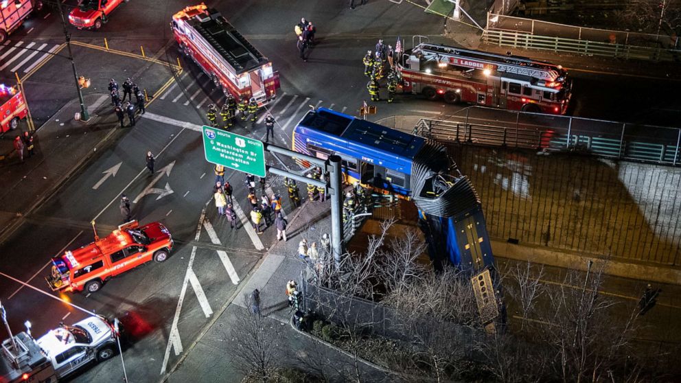 PHOTO: A bus that careened off a road in the Bronx neighborhood of New York City is seen left dangling from an overpass Friday, Jan. 15, 2021.
