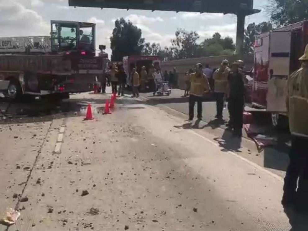 PHOTO: Twenty-five people were taken to the hospital after a bus passed through a highway separator and hit a car.