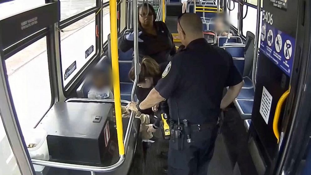 PHOTO:Milwaukee police and Milwaukee County Transit System (MCTS) driver Cecilia Nation-Gardner speak with a six-year-old boy the bus driver rescued from a busy intersection