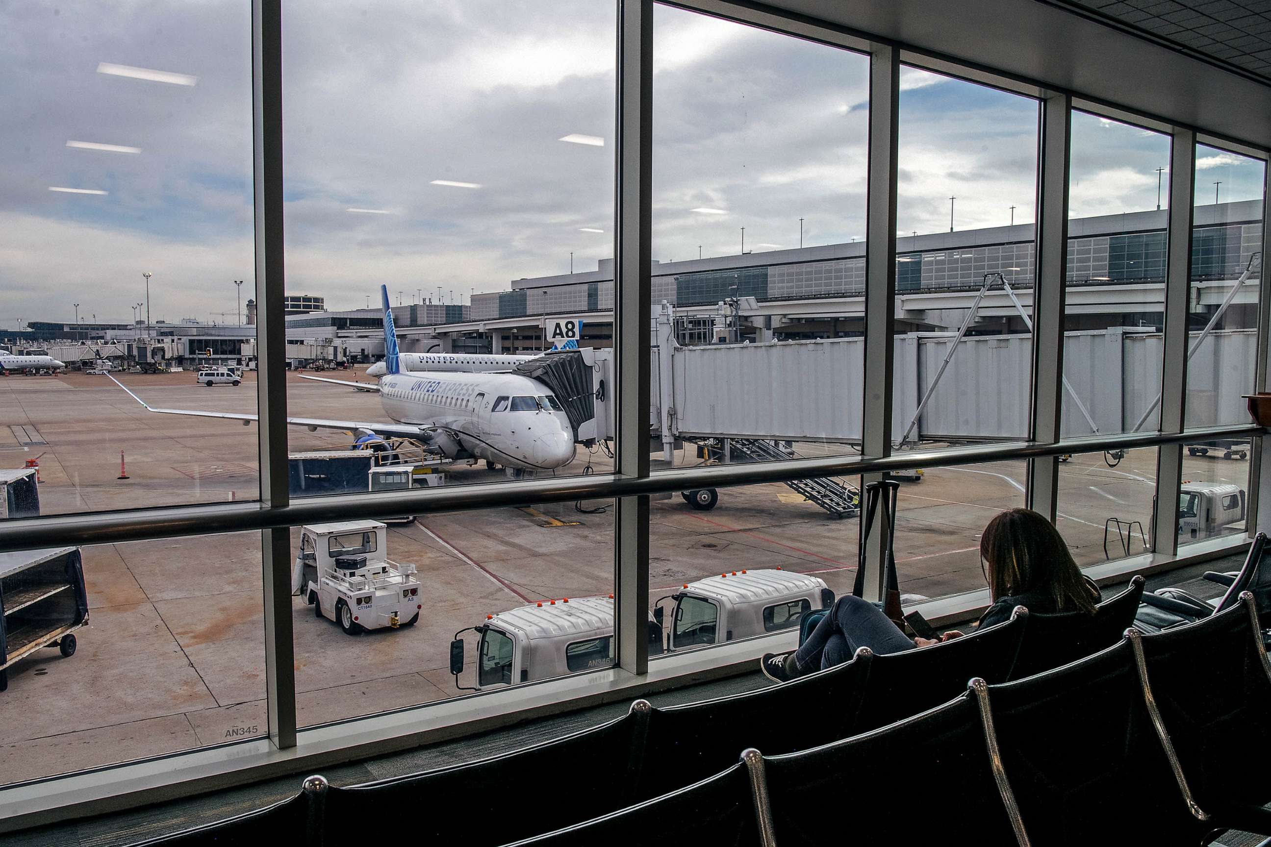 PHOTO: FILE - A person waits for their plane departure at George Bush Intercontinental Airport, Dec. 03, 2021 in Houston.