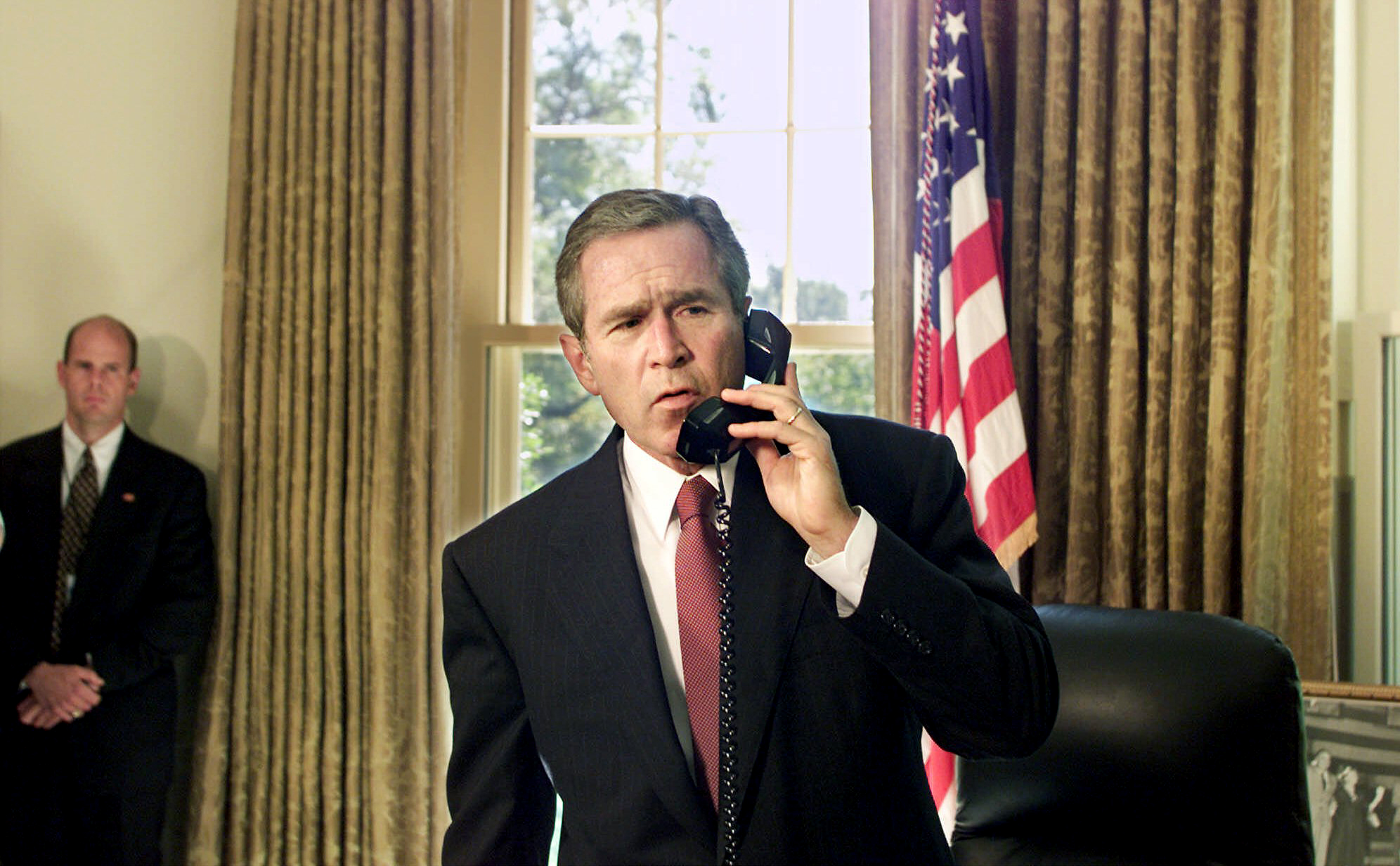 PHOTO: President George W. Bush speaks by telephone from the Oval Office at the White House in Washington, D.C., with New York City Mayor Rudolph Giuliani and New York Governor George Pataki, Sept. 13, 2001. 