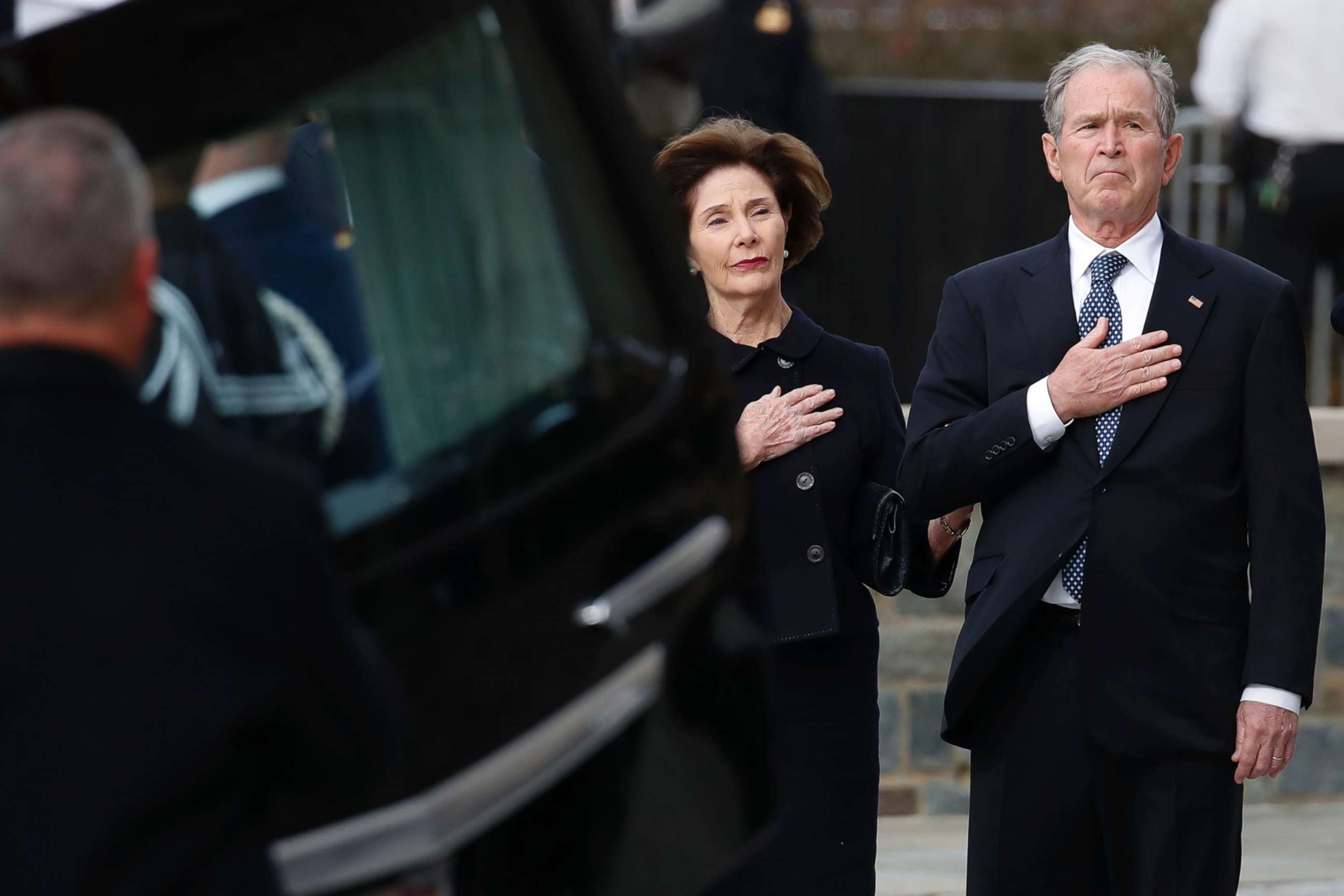 PHOTO: Former President George W. Bush and former first lady Laura Bush watch as the flag-draped casket of former President George H.W. Bush is carried to a State Funeral at the National Cathedral, Dec. 5, 2018 in Washington.