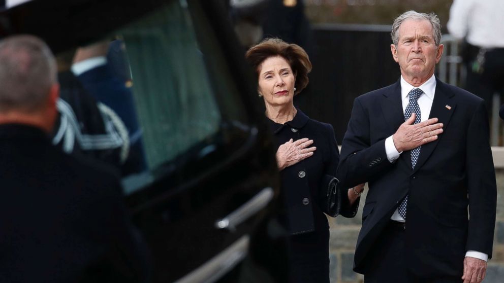 PHOTO: Former President George W. Bush and former first lady Laura Bush watch as the flag-draped casket of former President George H.W. Bush is carried to a State Funeral at the National Cathedral, Dec. 5, 2018 in Washington.