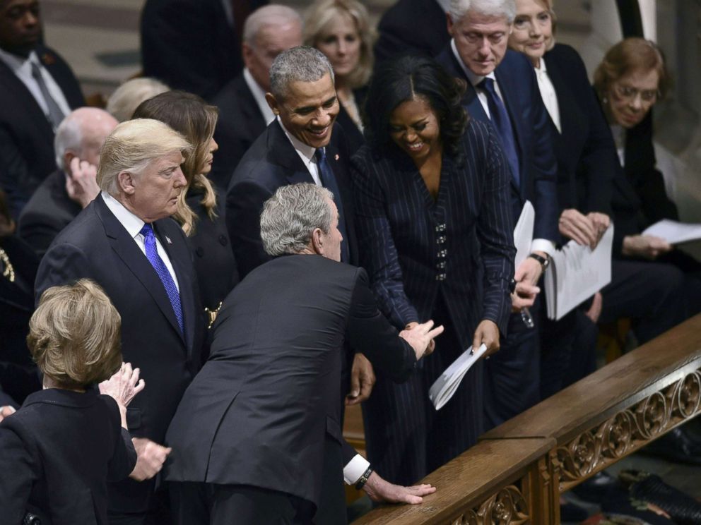 PHOTO: Former president George W. Bush reaches past President Donald Trump to greet former first Lady Michelle Obama during the funeral service for former President George H.W. Bush at the Washington National Cathedral, Dec. 5, 2018, Dec. 5, 2018.