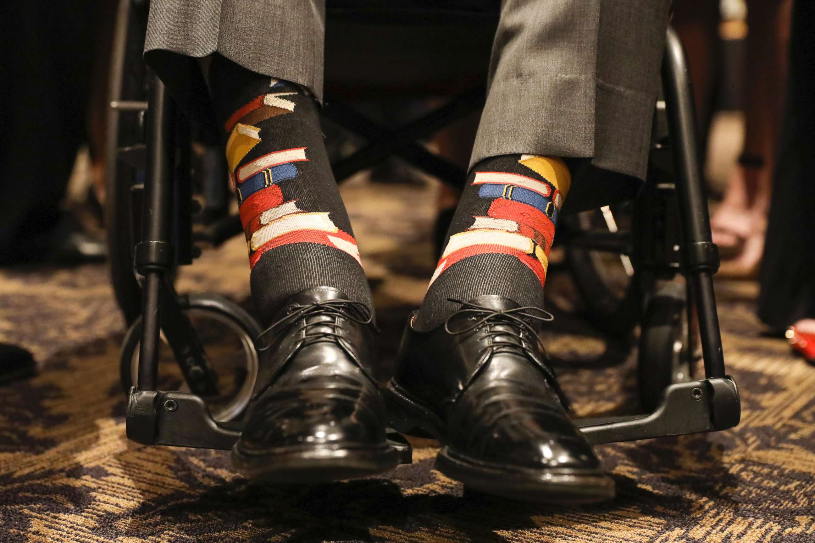 PHOTO: Former U.S. President George H.W. Bush wears socks printed with blue, red and yellow books during the funeral service for his wife, Barbara Bush, in Houston on April 21, 2018.