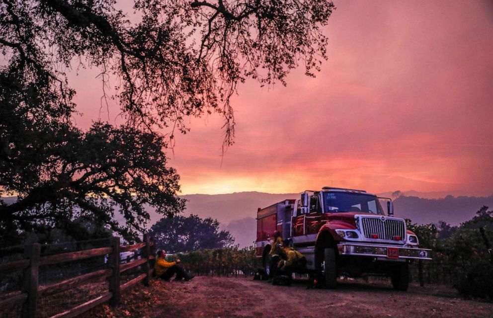 PHOTO: A fire engine waits at the top of a hill overseeing the Kincade Fire in the hills in Geyserville, California, on Thursday, Oct. 24, 2019.