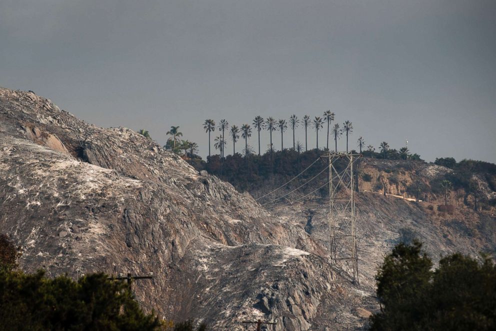 PHOTO: Torched hills from the Thomas wildfire burns in Carpinteria, Calif. on Dec. 11, 2017. The fire destroyed hundreds of homes and prompted massive mandatory evacuations. 