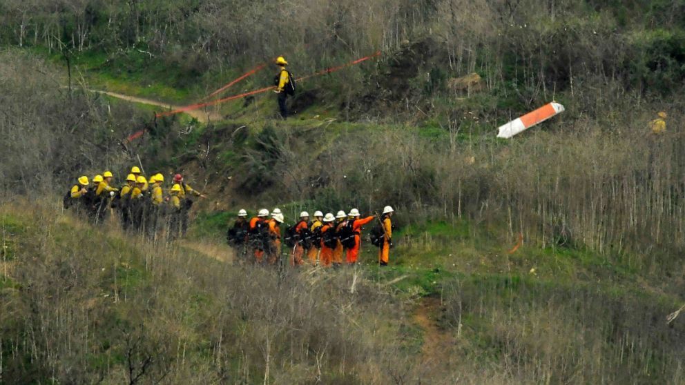 PHOTO: Firefighters work the scene of a helicopter crash where former NBA star Kobe Bryant died, Jan. 26, 2020, in Calabasas, Calif. 