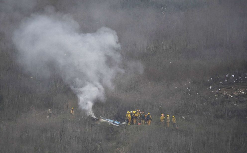 PHOTO: LA county firefighters on the scene of a helicopter crash that killed Kobe Bryant in Calabasas, Calif., Jan. 26, 2020. 