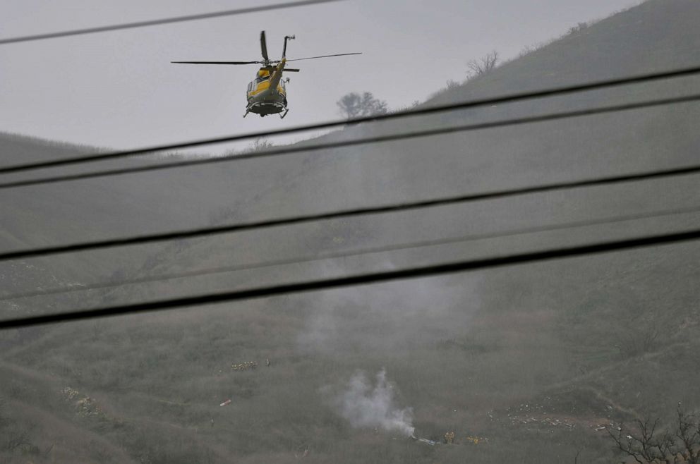 PHOTO: LA county firefighters on the scene of a helicopter crash that killed Kobe Bryant in Calabasas, Calif., Jan. 26, 2020. 