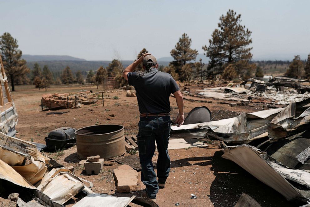 PHOTO: Michael Salazar walks at his property burned during the Hermits Peak and Calf Canyon fires, in Tierra Monte, N.M., May 11, 2022.
