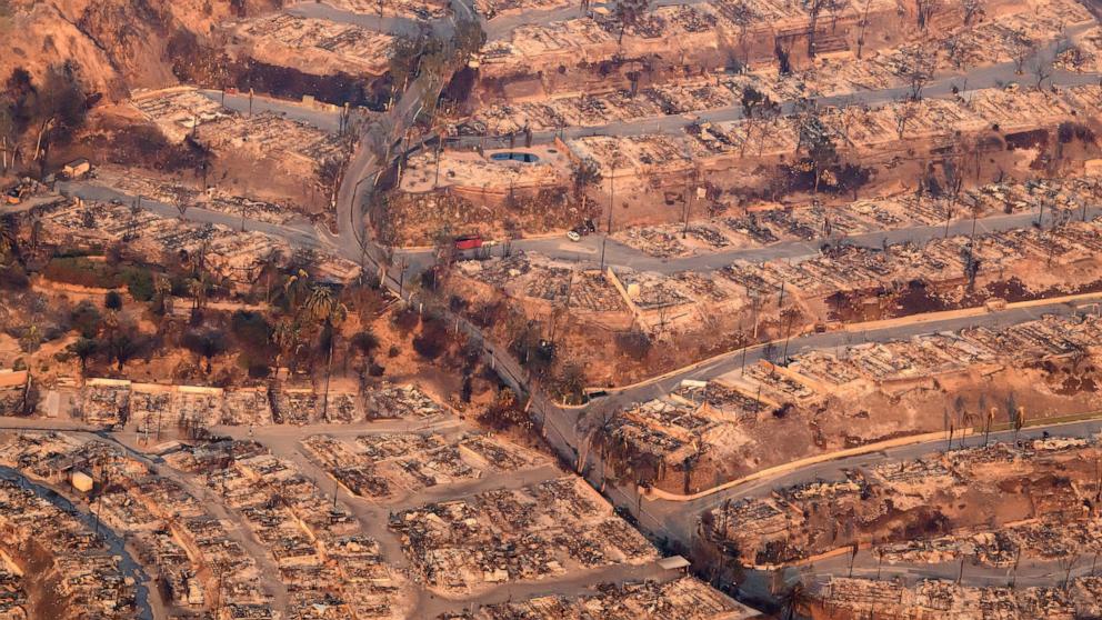 PHOTO: In this aerial view taken from a helicopter, homes burned from the Palisade fire smolder near the Pacific Palisades neighborhood of Los Angeles, Jan. 9, 2025.