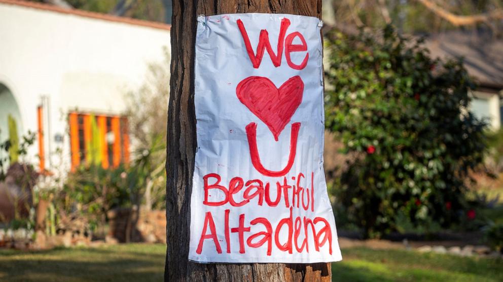 PHOTO: A banner is attached to a tree after residents fled from the Eaton Fire, one of six simultaneous blazes that have ripped across Los Angeles County, in Altadena, Calif., Jan. 11, 2025