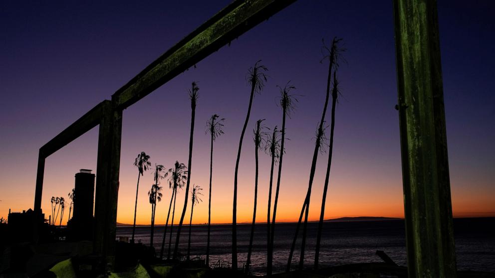 PHOTO: The sun rises behind a fire-ravaged beachfront property in the aftermath of the Palisades Fire, Jan. 13, 2025, in Malibu, Calif. 