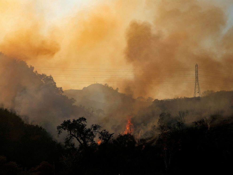 FILE PHOTO: The Bond Fire wildfire burns next to electrical power lines near Modjeska Canyon, California, U.S., December 3, 2020. 