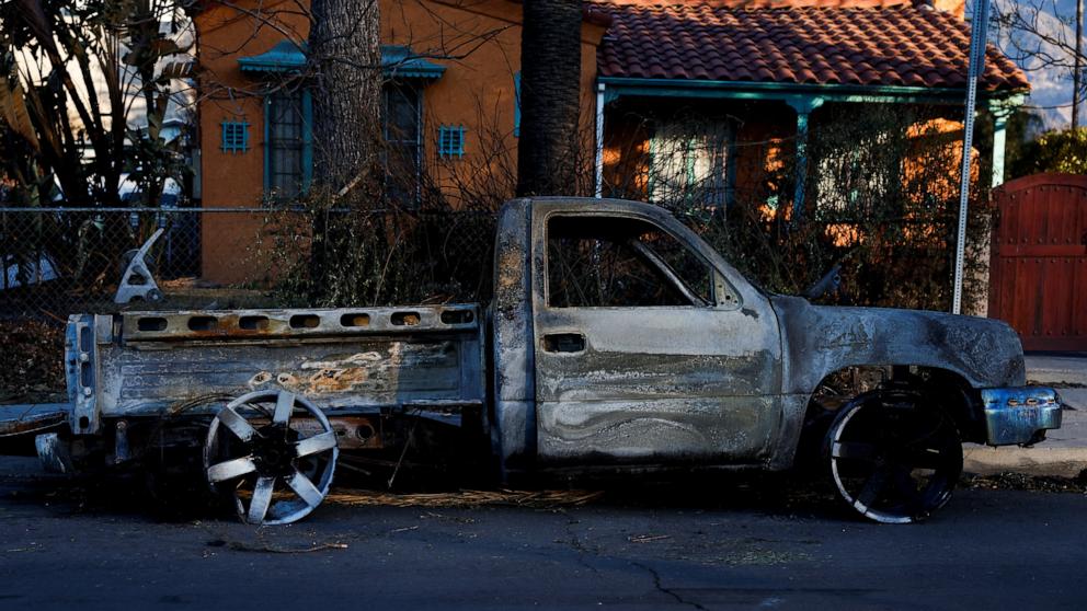 PHOTO: A burnt car is parked on a street, as the Eaton Fire continues, in Altadena, Calif., Jan. 13, 2025. 