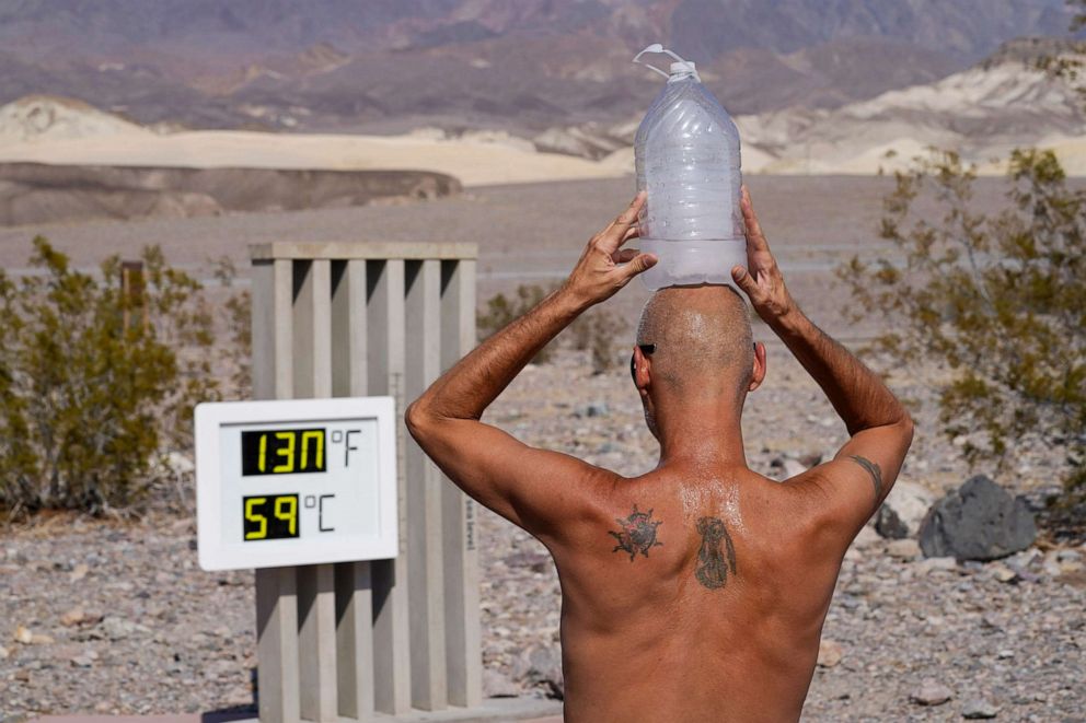 PHOTO: A man cools off with a bottle of ice water on his head in Death Valley National Park, Calif., Aug. 17, 2020. The temperature in the park reached 130 degrees on Aug. 16, hitting what may be the hottest temperature recorded on Earth since 1913.