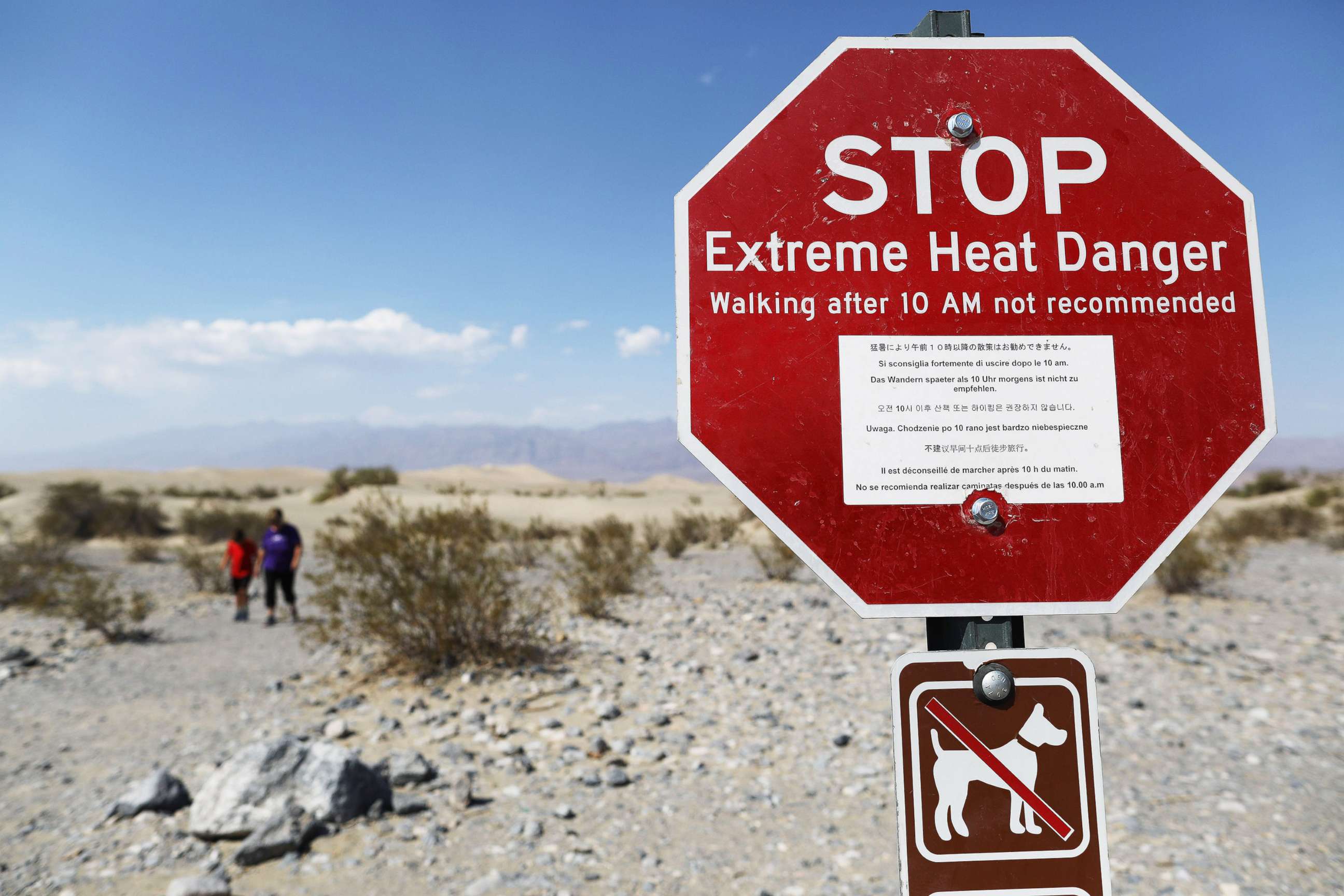 PHOTO: Visitors walk near a sign warning of extreme heat danger in Death Valley National Park, Calif., on Aug. 17, 2020. The temperature in the park reached 130 degrees on Aug. 16, one of the highest temperatures ever recorded.