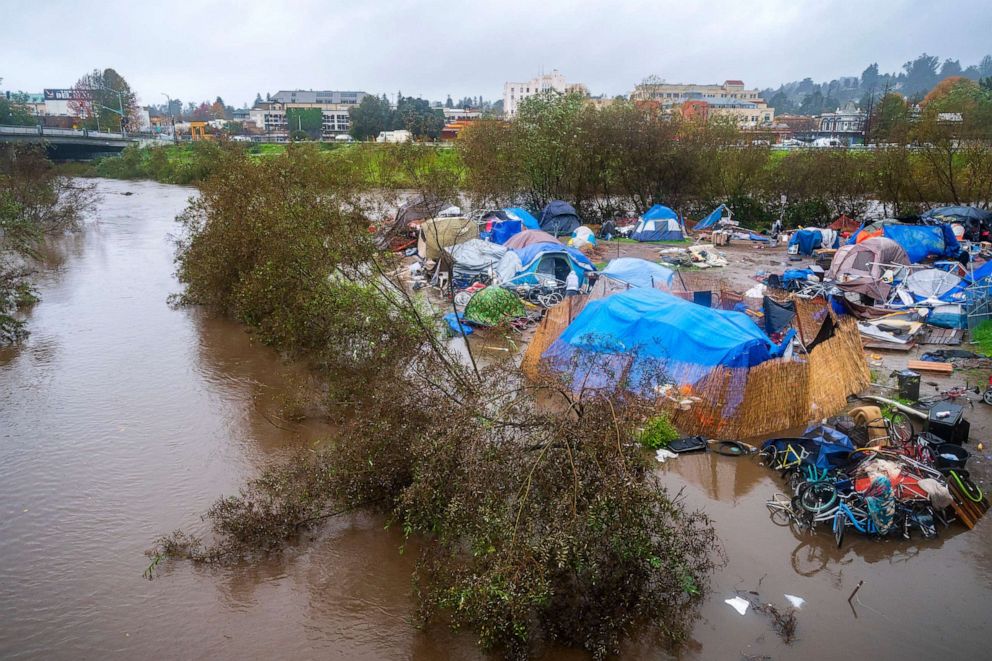PHOTO: Bloated by heavy rains, the San Lorenzo River partially floods a homeless encampment at Riverwalk Park in Santa Cruz, Calif., Dec. 13, 2021.