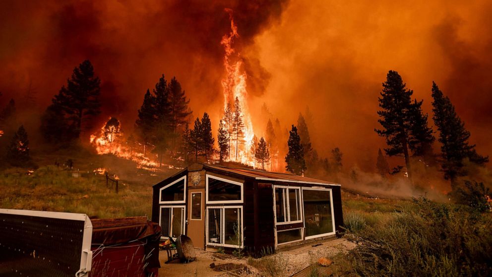 PHOTO: The Tamarack Fire burns behind a greenhouse in the Markleeville community of Alpine County, Calif., July 17, 2021.