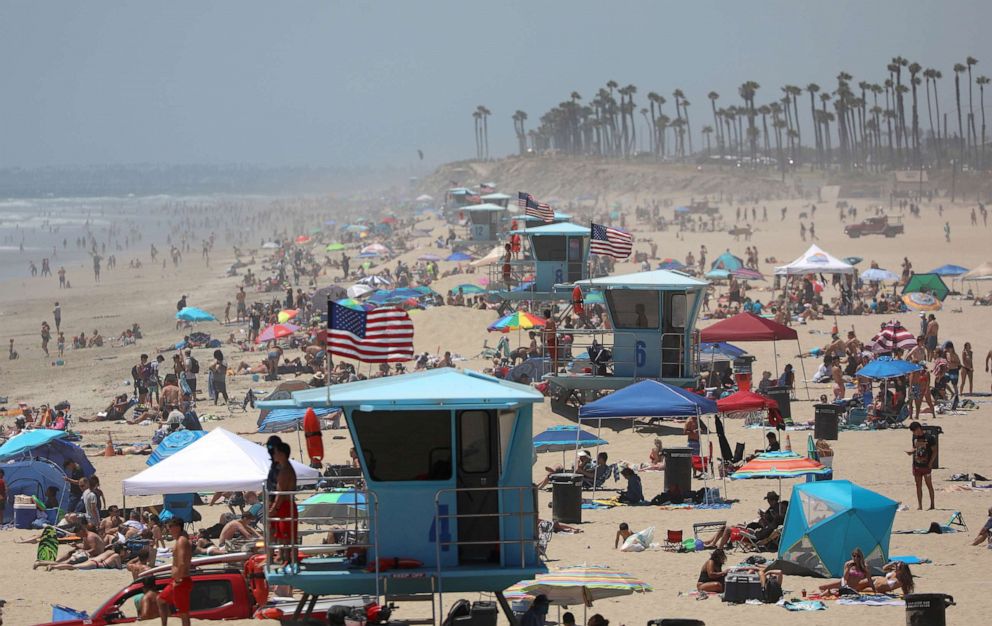 PHOTO: People gather at the beach on July 3, 2020 in Huntington Beach, Calif.