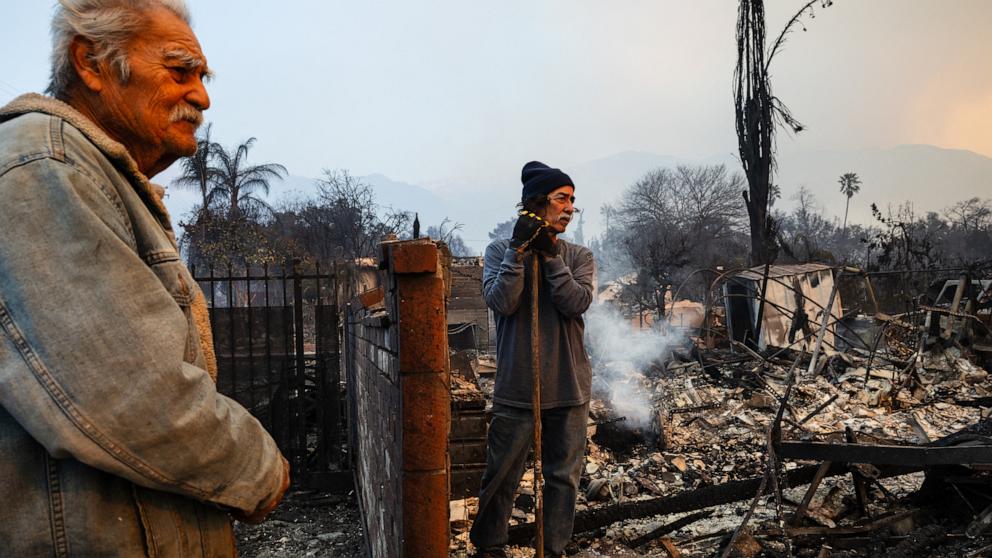 PHOTO: Richard Castaneda (L) and Rupert Garcia look at the ruins of Garcia's home destroyed by the Eaton Fire in Altadena, California, Jan. 9, 2025. 