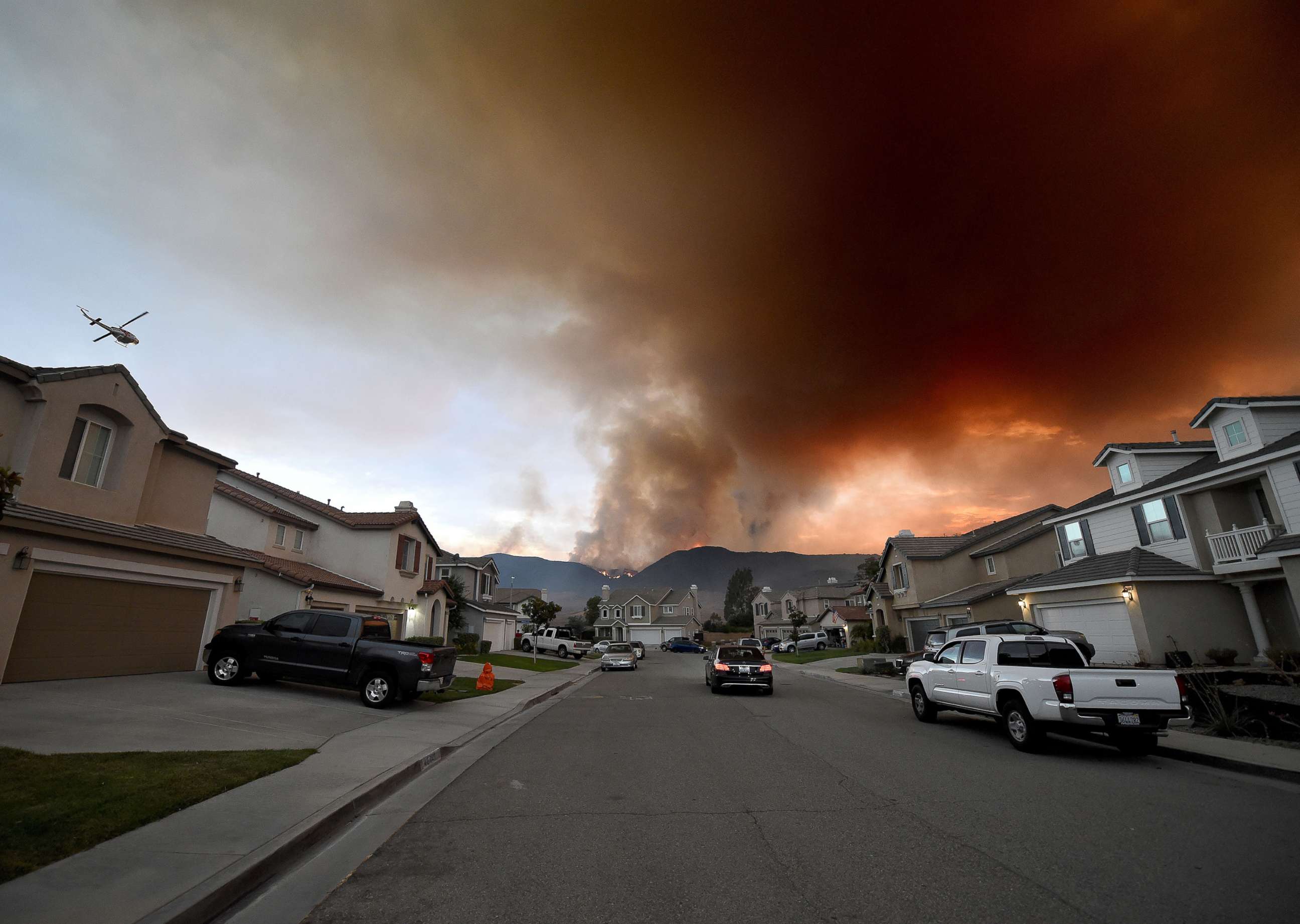 PHOTO: A fire burns in and above Cole Canyon behind homes on Sherry Lane in Murrieta, Calif., Sep 4, 2019.