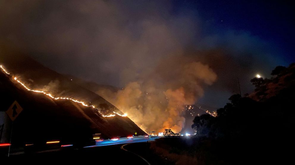 PHOTO: The Shell Fire burns vegetation on a hill along a highway in Kern County, Calif., June 27, 2021.