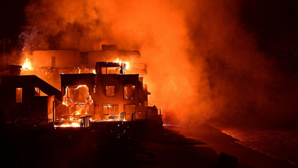 PHOTO: A beach house is engulfed in flames as the Palisades Fire burns along Pacific Coast Highway in Malibu, Calif., on Jan. 8, 2025. 