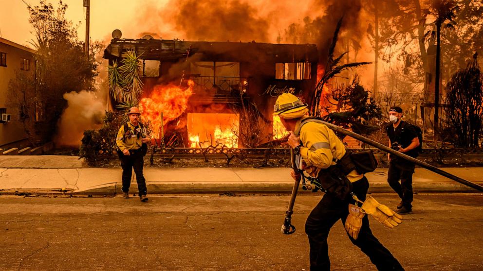 PHOTO: Firefighters work the scene as an apartment building burns during the Eaton fire in the Altadena area of Los Angeles county, Calif., on Jan. 8, 2025. 