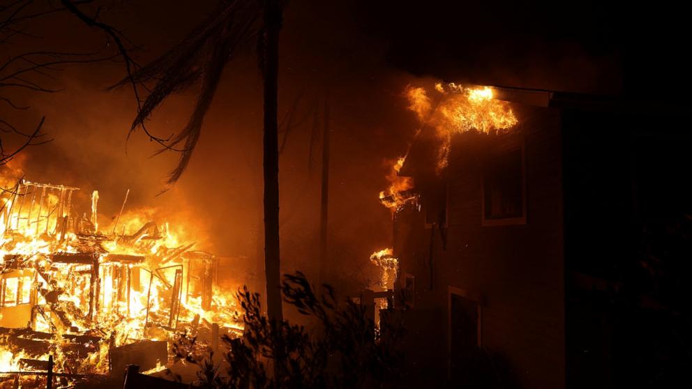 PHOTO: Flames rise from a structure as the Eaton Fire burns in Pasadena, Calif., Jan. 8, 2025.