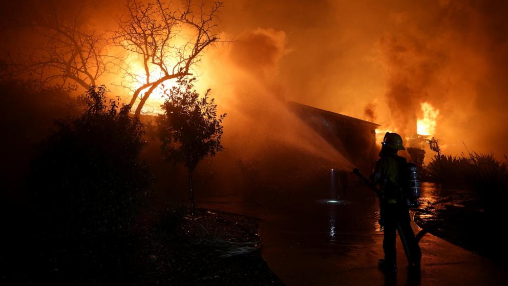 PHOTO: A firefighter works to extinguish flames as the Eaton Fire burns in Pasadena, Calif., Jan. 8, 2025.