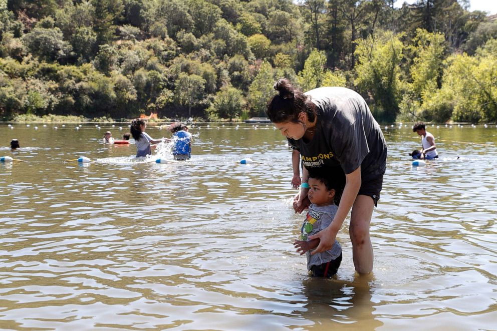 PHOTO: People cool off at Lake Temescal at the Temescal Regional Recreation Area in Oakland, Calif., June 21, 2022, during a heatwave.