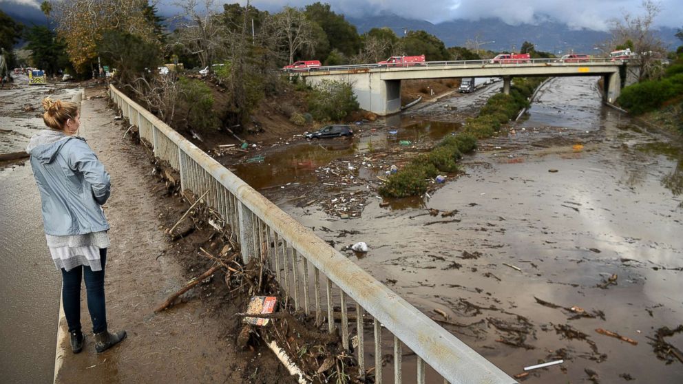 PHOTO: A woman looks at the 101 freeway from Olive Mill Road in Montecito, Calif., Jan. 9. 2018, after heavy rainfall brought mudslides and debris cascading down from hillsides denuded by recent wildfires.