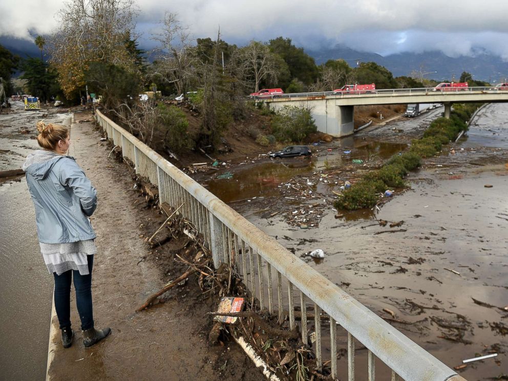 PHOTO: A woman looks at the 101 freeway from Olive Mill Road in Montecito, Calif., Jan. 9. 2018, after heavy rainfall brought mudslides and debris cascading down from hillsides denuded by recent wildfires.